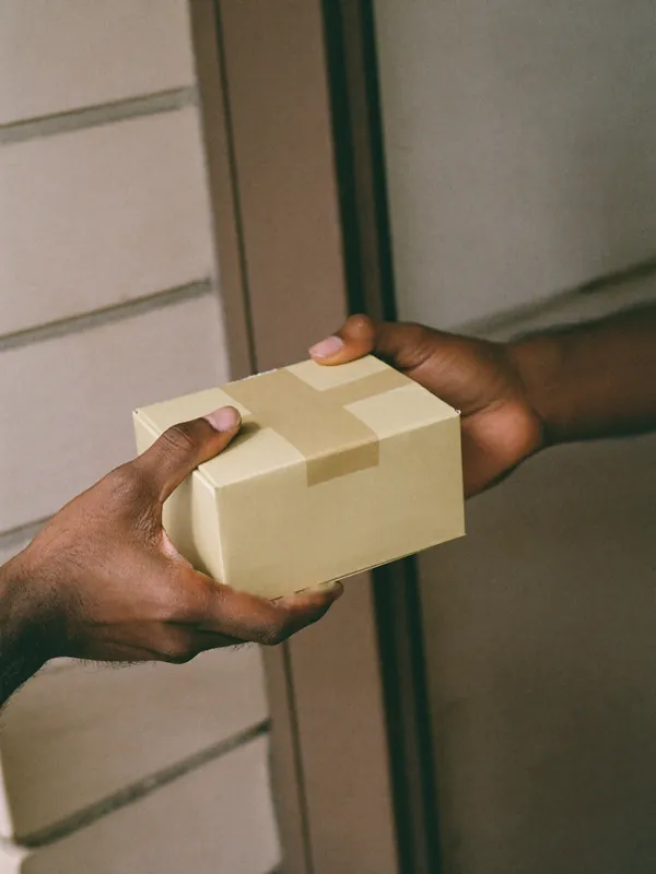 A plain box being handed over at a door